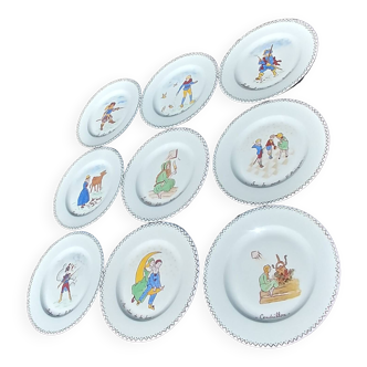 Set of nine Limoges porcelain flat plates signed "Guérin"