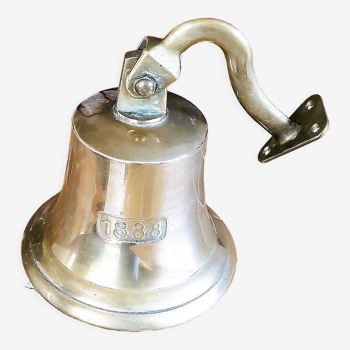 Polished brass bell with its stem