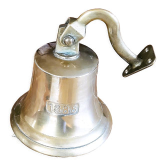 Polished brass bell with its stem