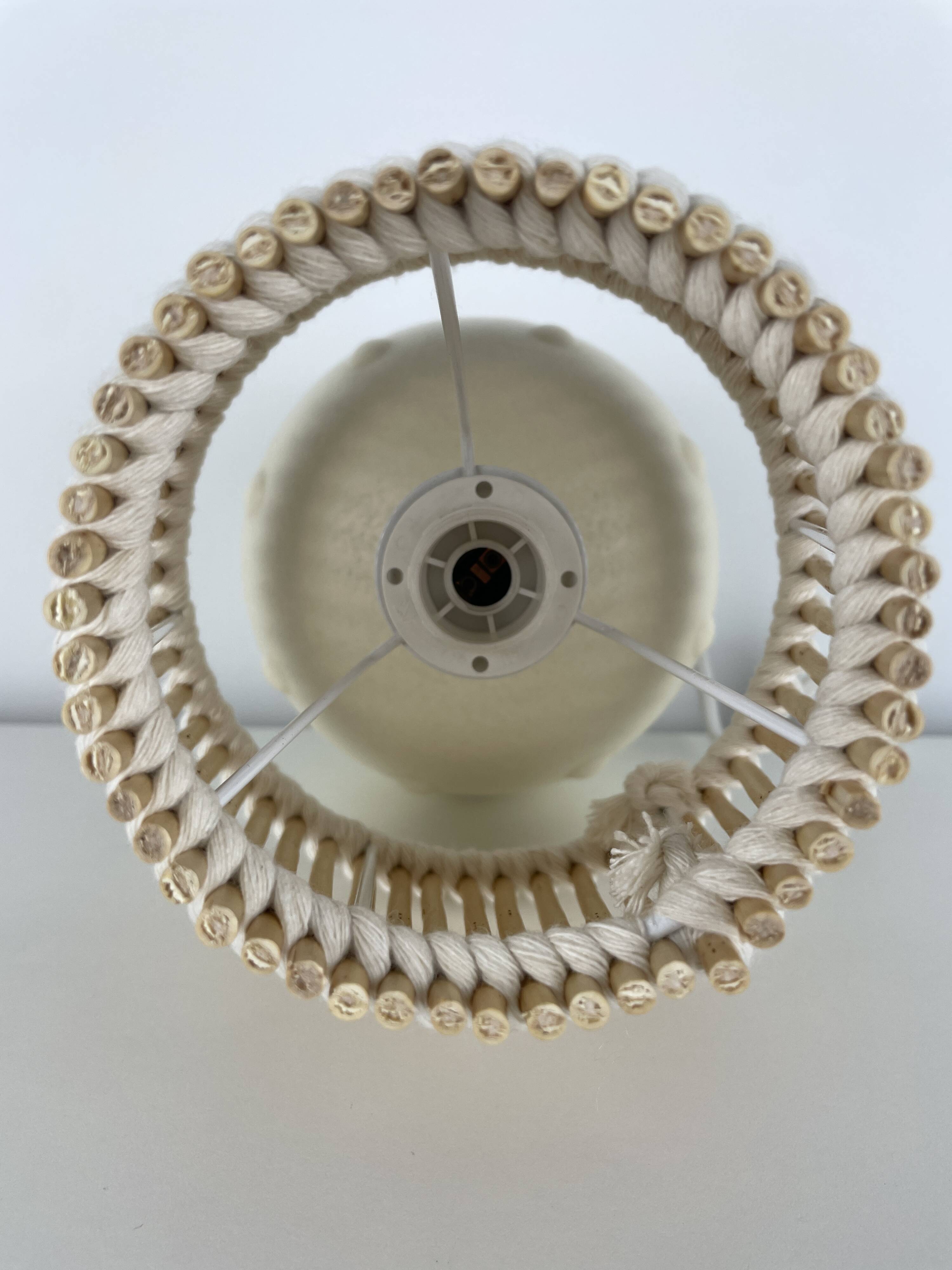 Vintage ceramic lamp with wicker and cotton shade.