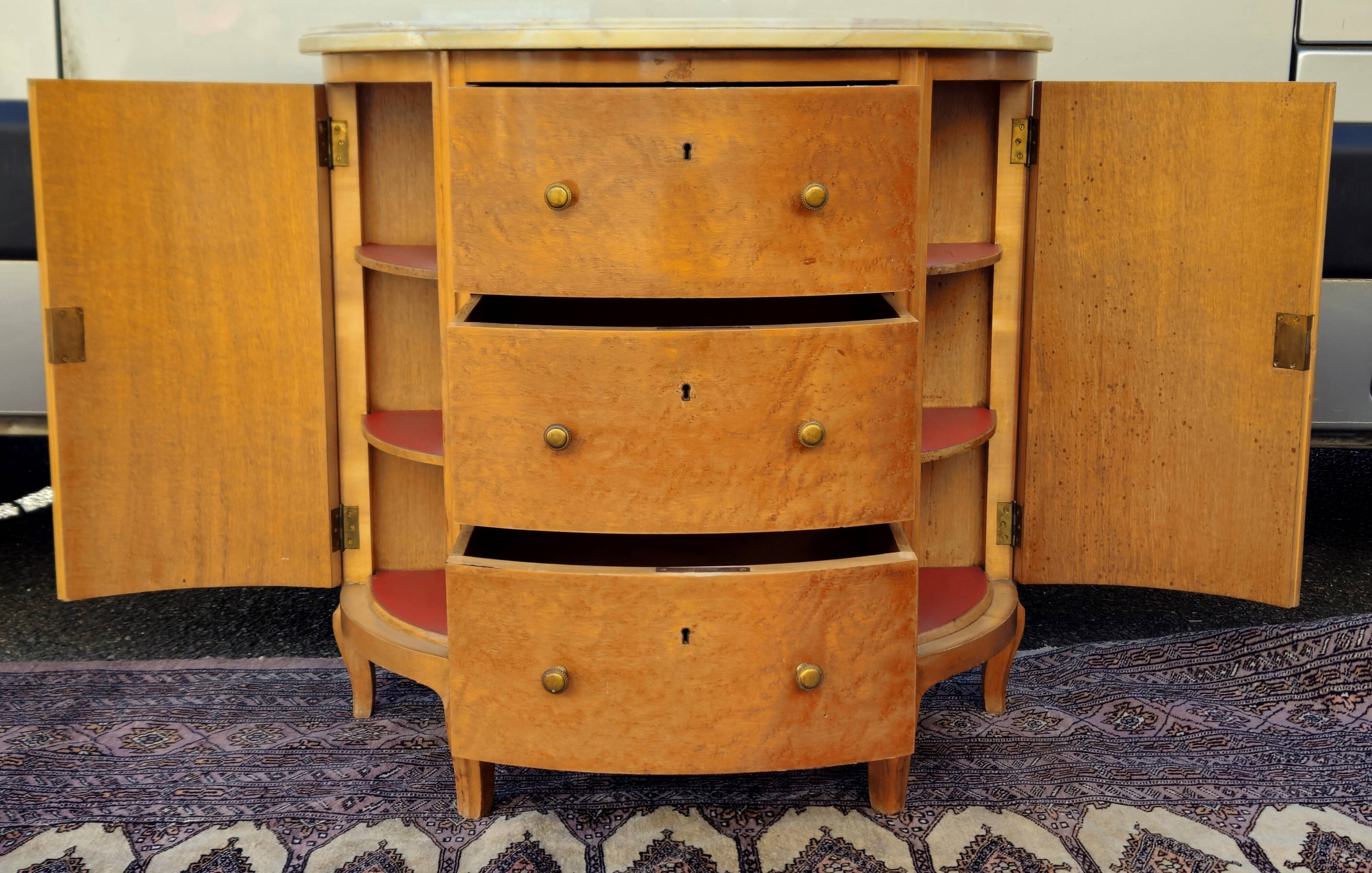 Half-moon commode in burl wood with a marble top.