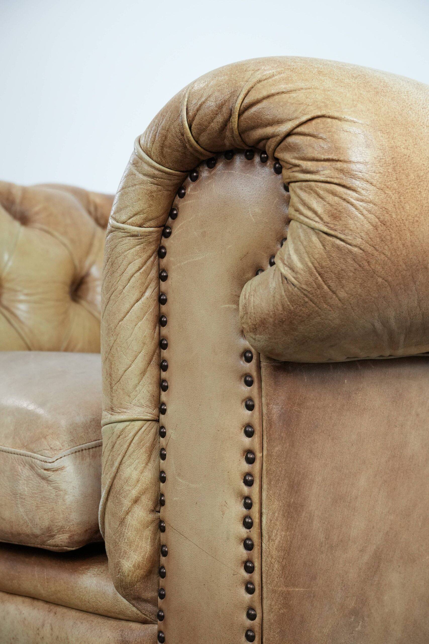 Chesterfield armchair made of cowhide leather in a light cognac colour