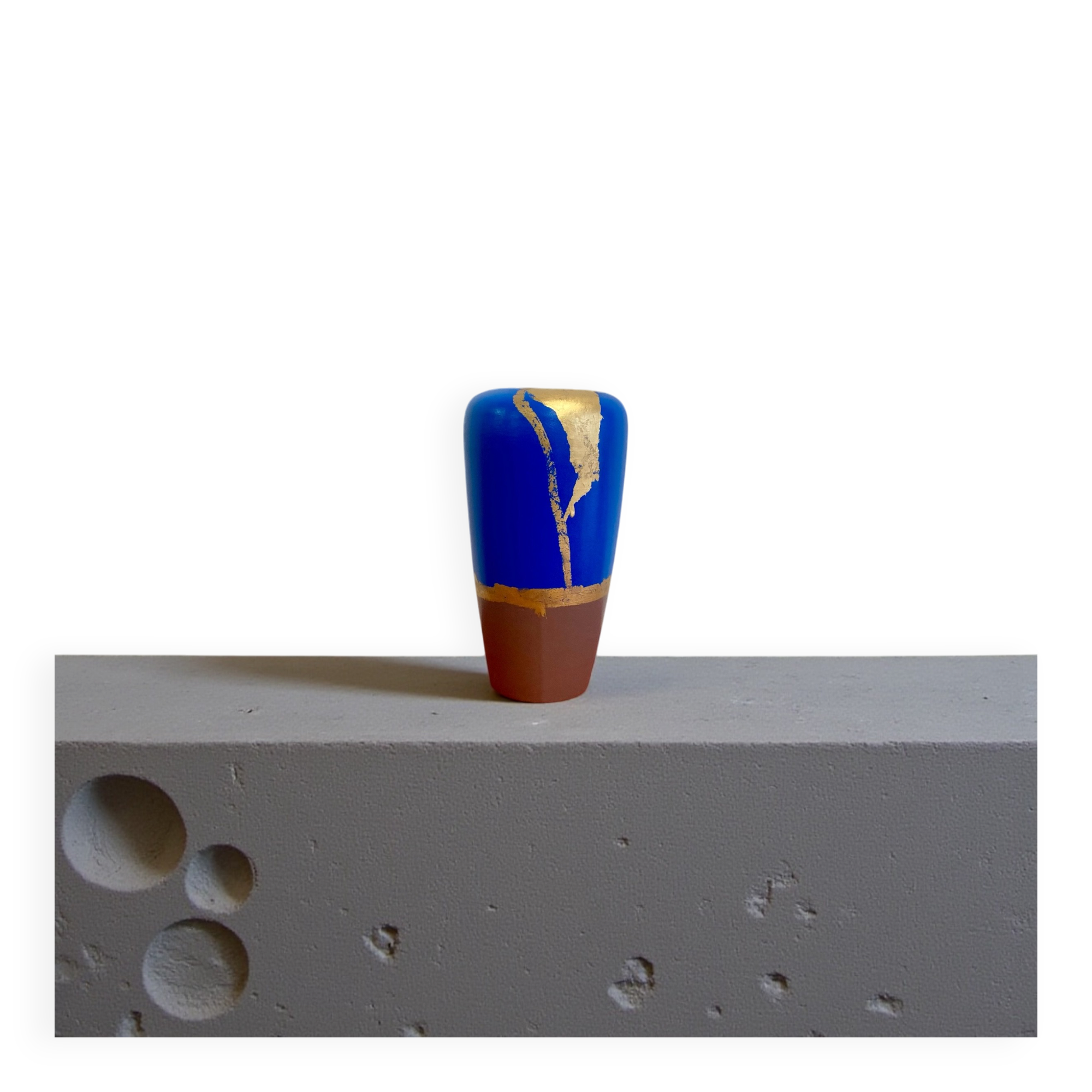 Electric blue and frosted brown decorative vase with gold leaf.