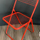 Red "Ted Ned" folding chair by Niels Gammelgaard