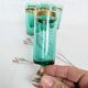 Set of 6 green champagne flutes with a golden rim.