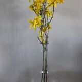 Antique glass carafe with a round belly and floral neck.