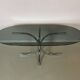 Vintage coffee table from the 70s in smoked glass and chrome, oval, Space Age style.