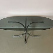 Vintage coffee table from the 70s in smoked glass and chrome, oval, Space Age style.