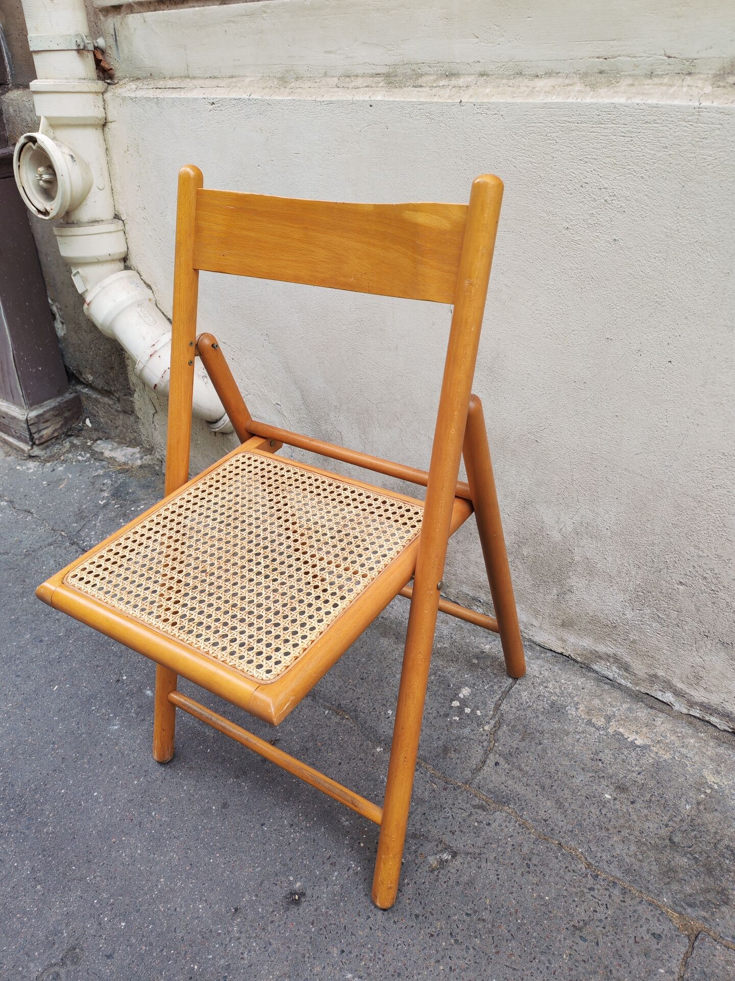 Wooden folding chair with caning from the 1980s.