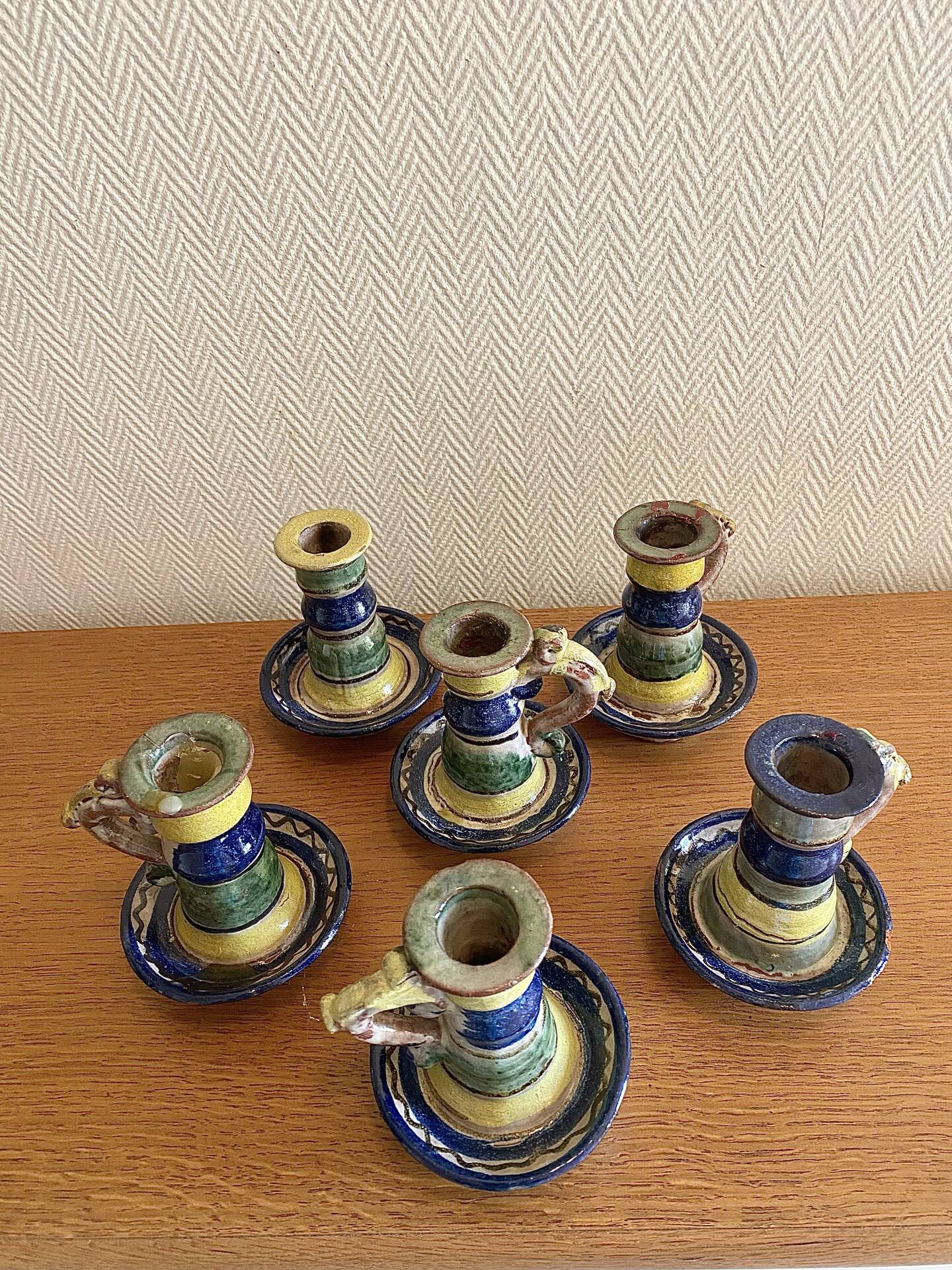 Many old glazed terracotta candlesticks.