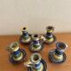 Many old glazed terracotta candlesticks.