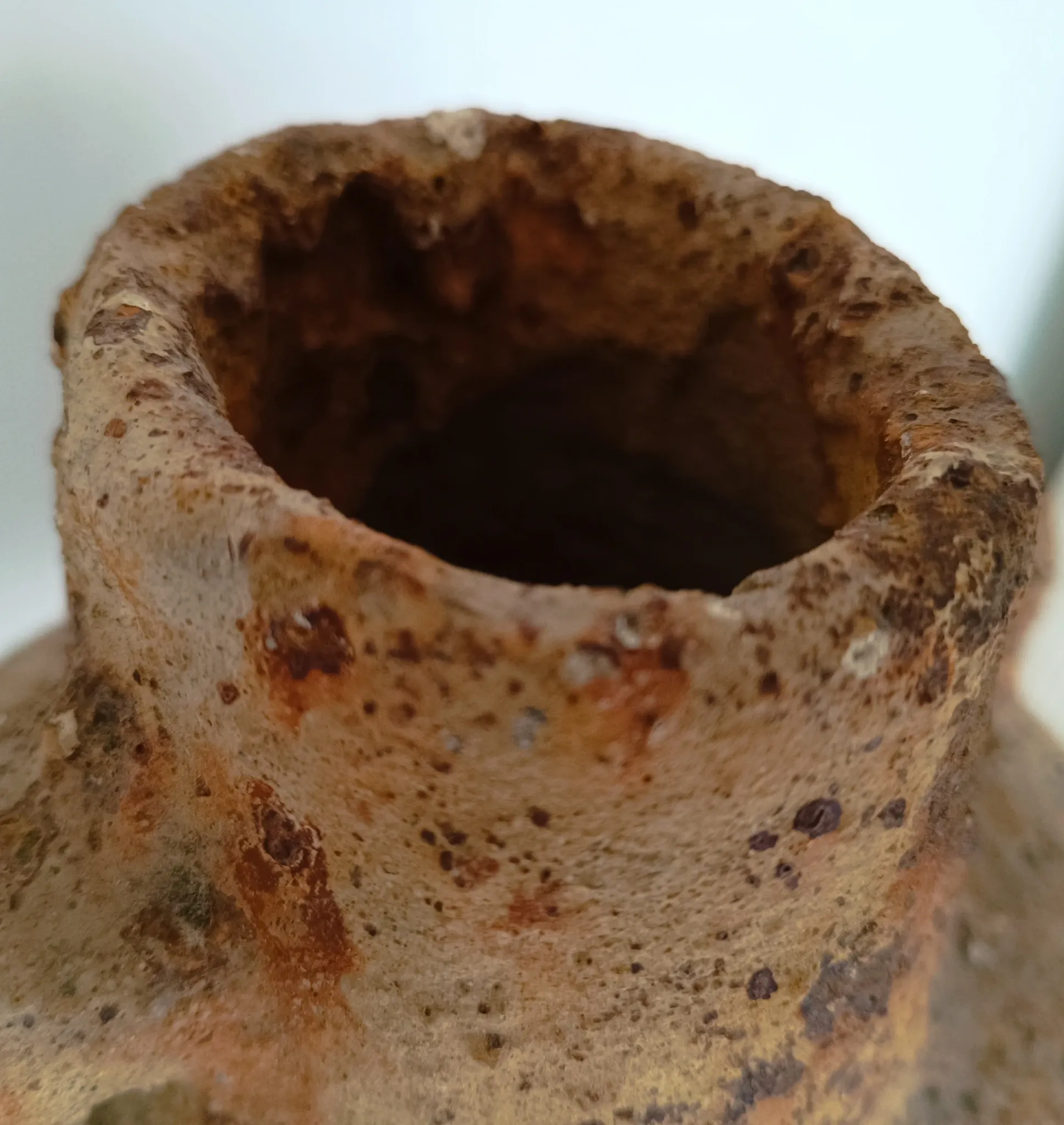 Textured terracotta vase in wabi-sabi style