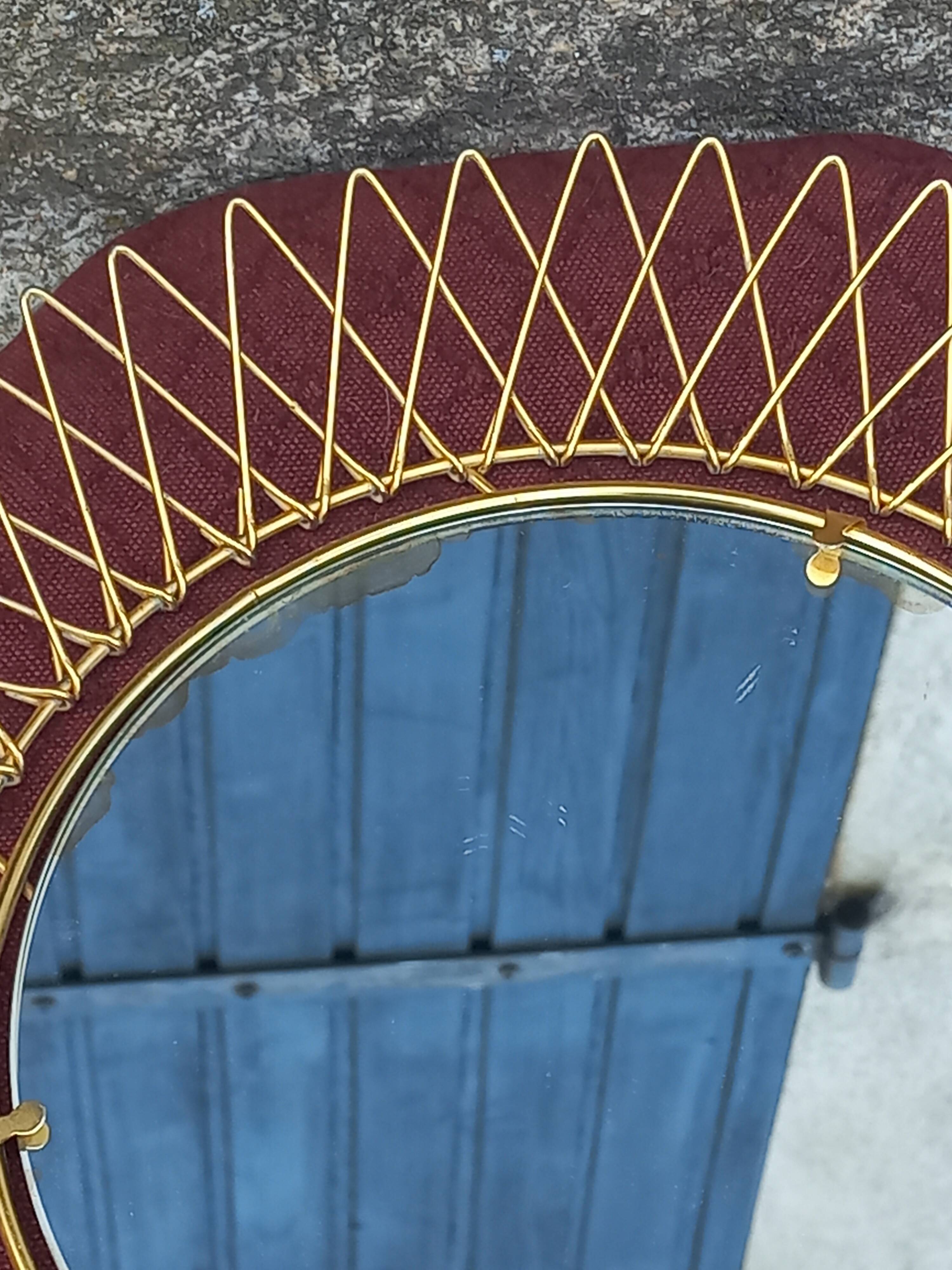 Vintage 1950s sun mirror in gold metal.