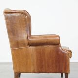 Graceful, stylish, timeless and comfortable wing chair made of cowhide in English style