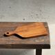 Rectangular solid teak chopping board with elongated handle 30x16.
