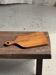 Rectangular solid teak chopping board with elongated handle 30x16.