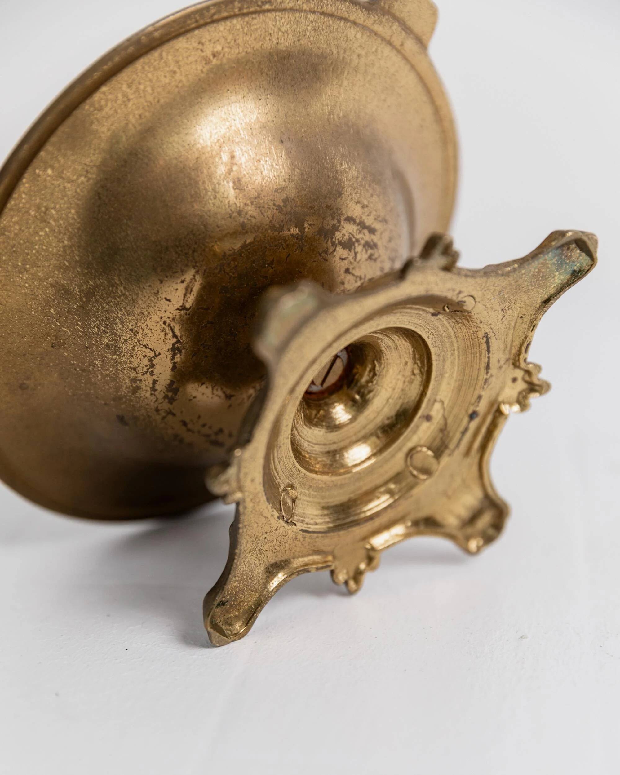 Vintage brass ashtray from the 1940s with a nude boy figurine on a footed base.