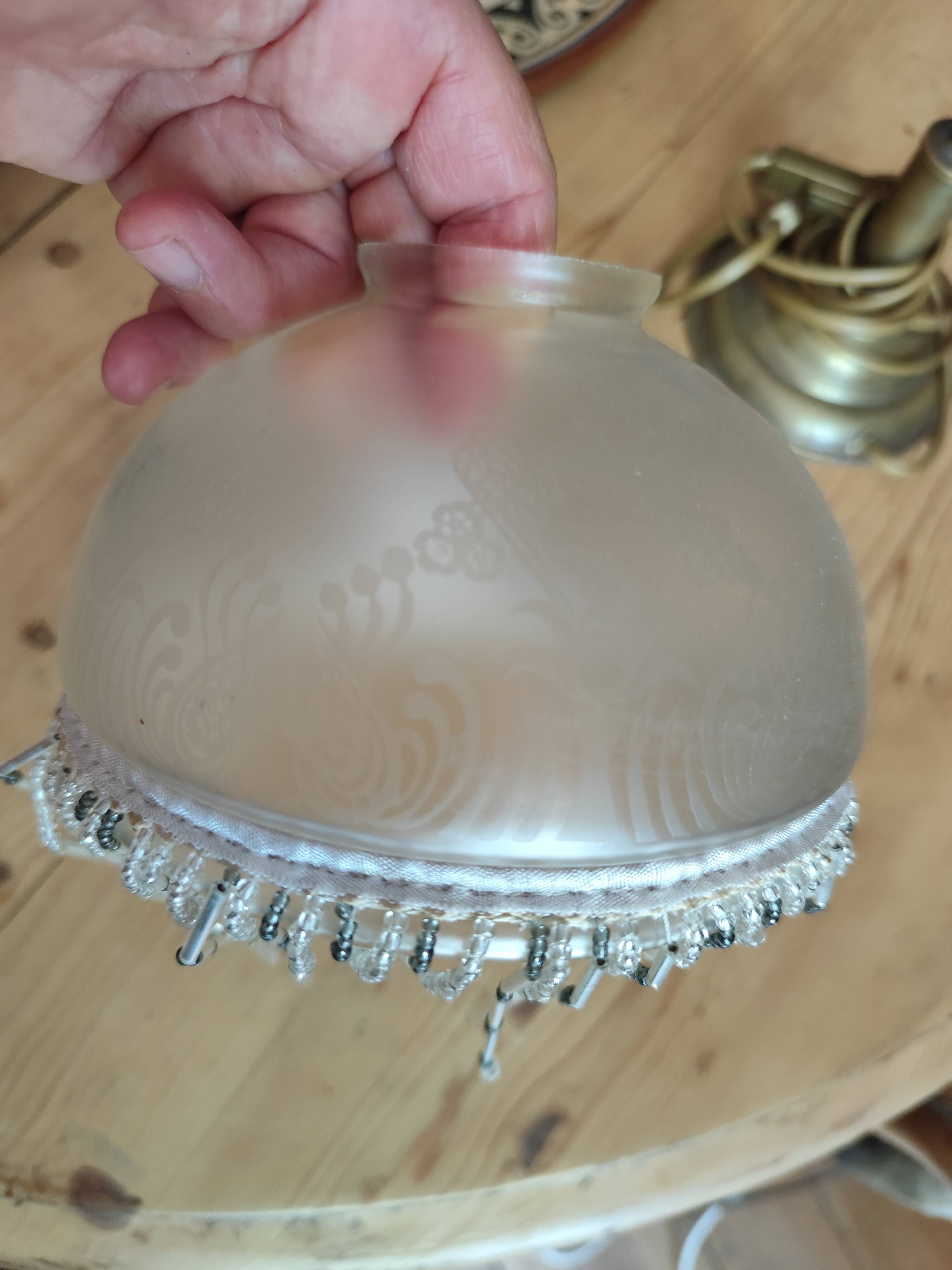 Retro brass lamp with a glass shade and bead fringes.