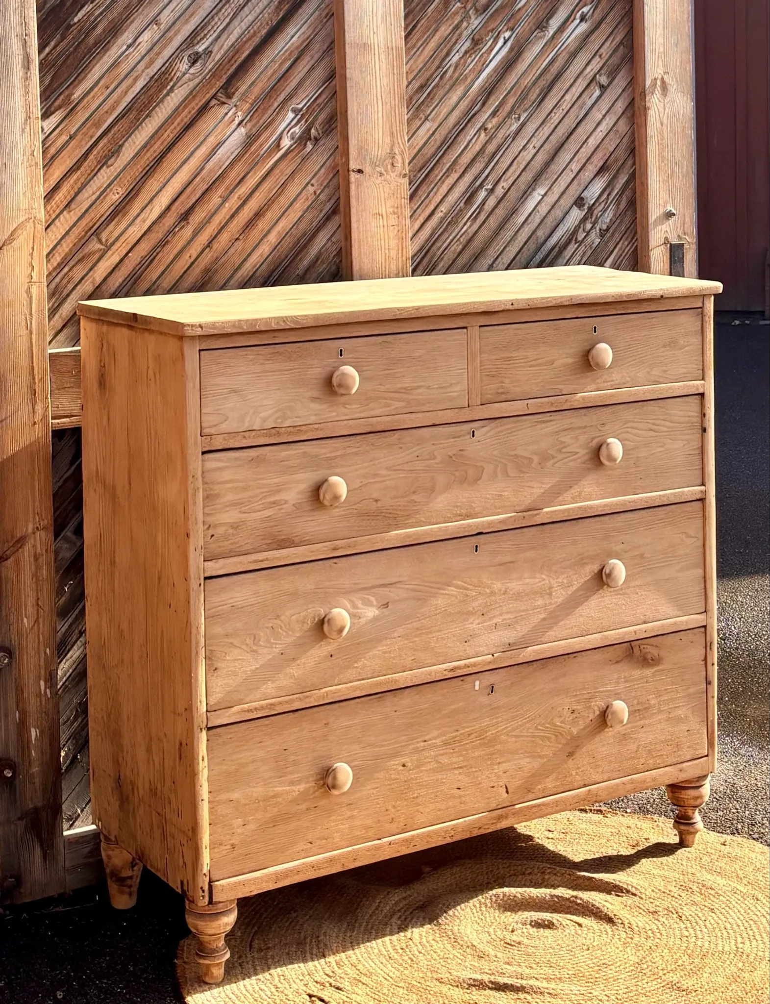 Large antique English chest of drawers in raw solid oak.
