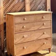 Large antique English chest of drawers in raw solid oak.