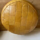 2 poufs moutarde patchwork en cuir de Sède