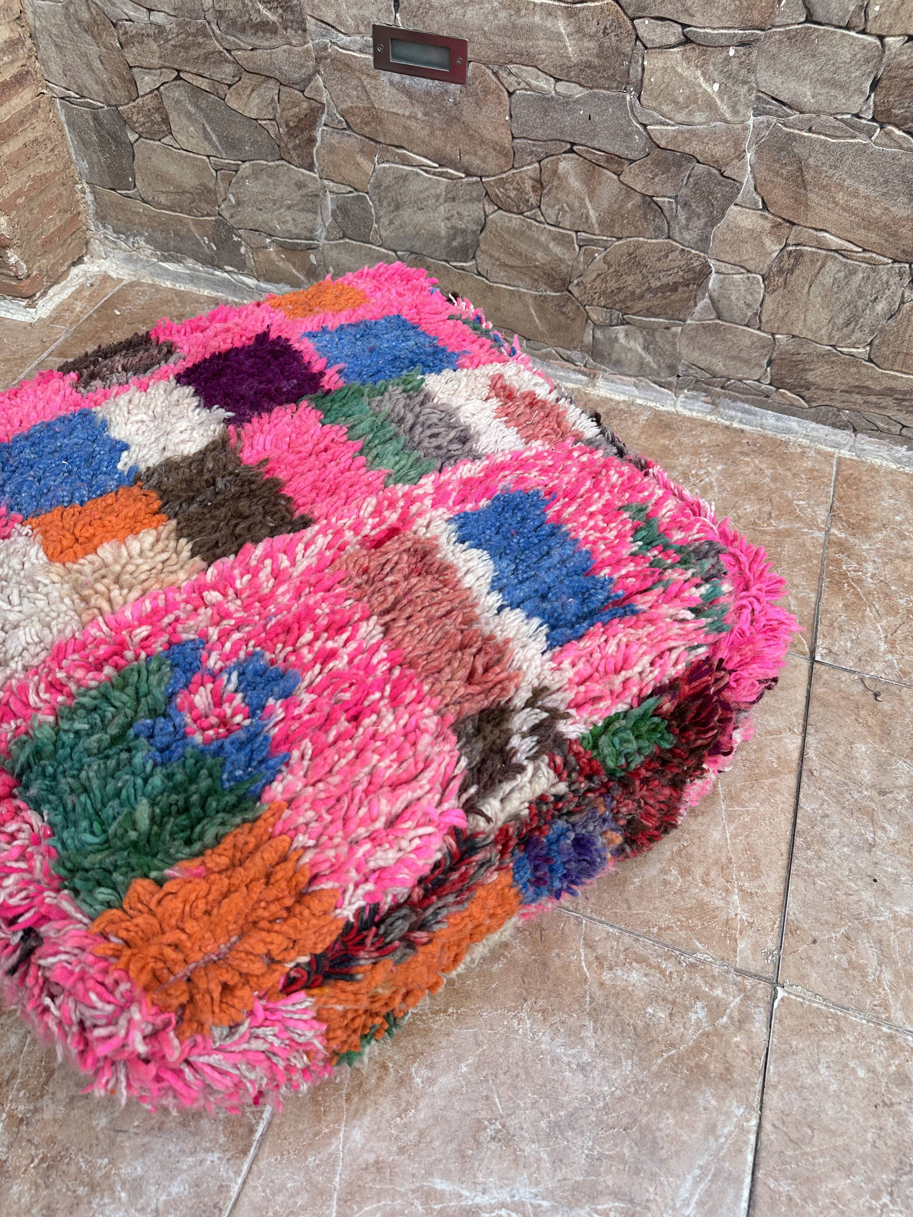 Berber floor pouf: Handwoven Moroccan wool cushion.