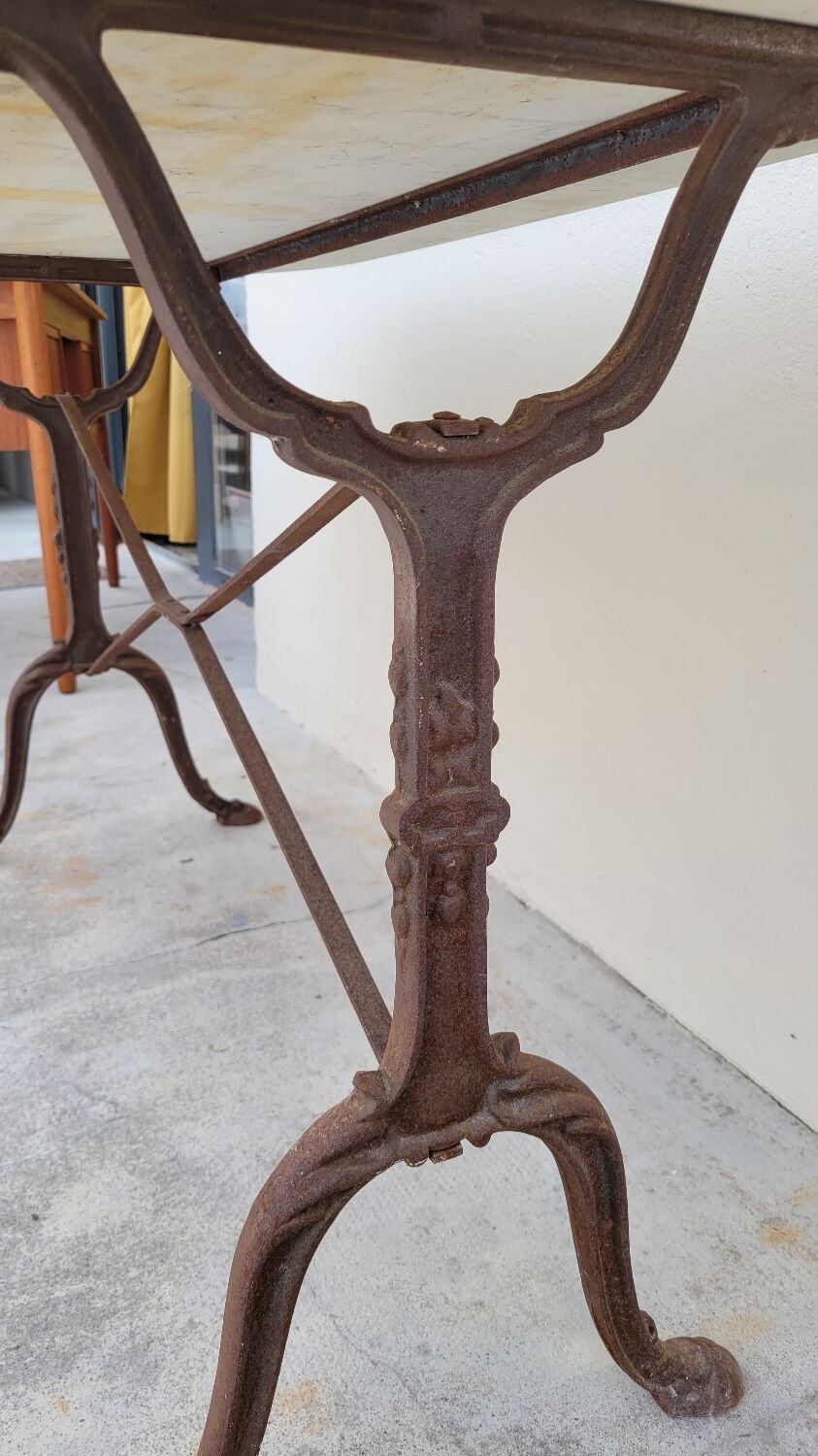 Restaurant bistro table in oval marble and decorated cast iron bases -1m51