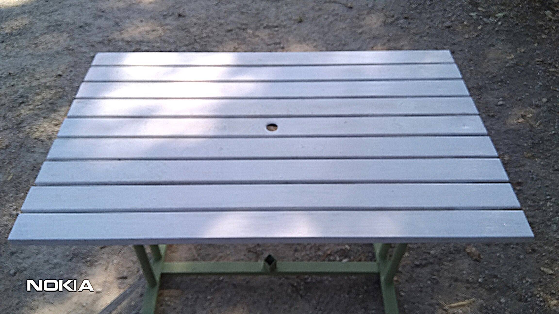 Old garden table with iron slats