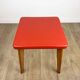Wooden stool with red faux leather from the 1950s.