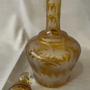 Amber bohemian glass liqueur carafe decorated with a stag in the forest.