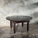 Antique round coffee table in Indonesian teak with turned legs.