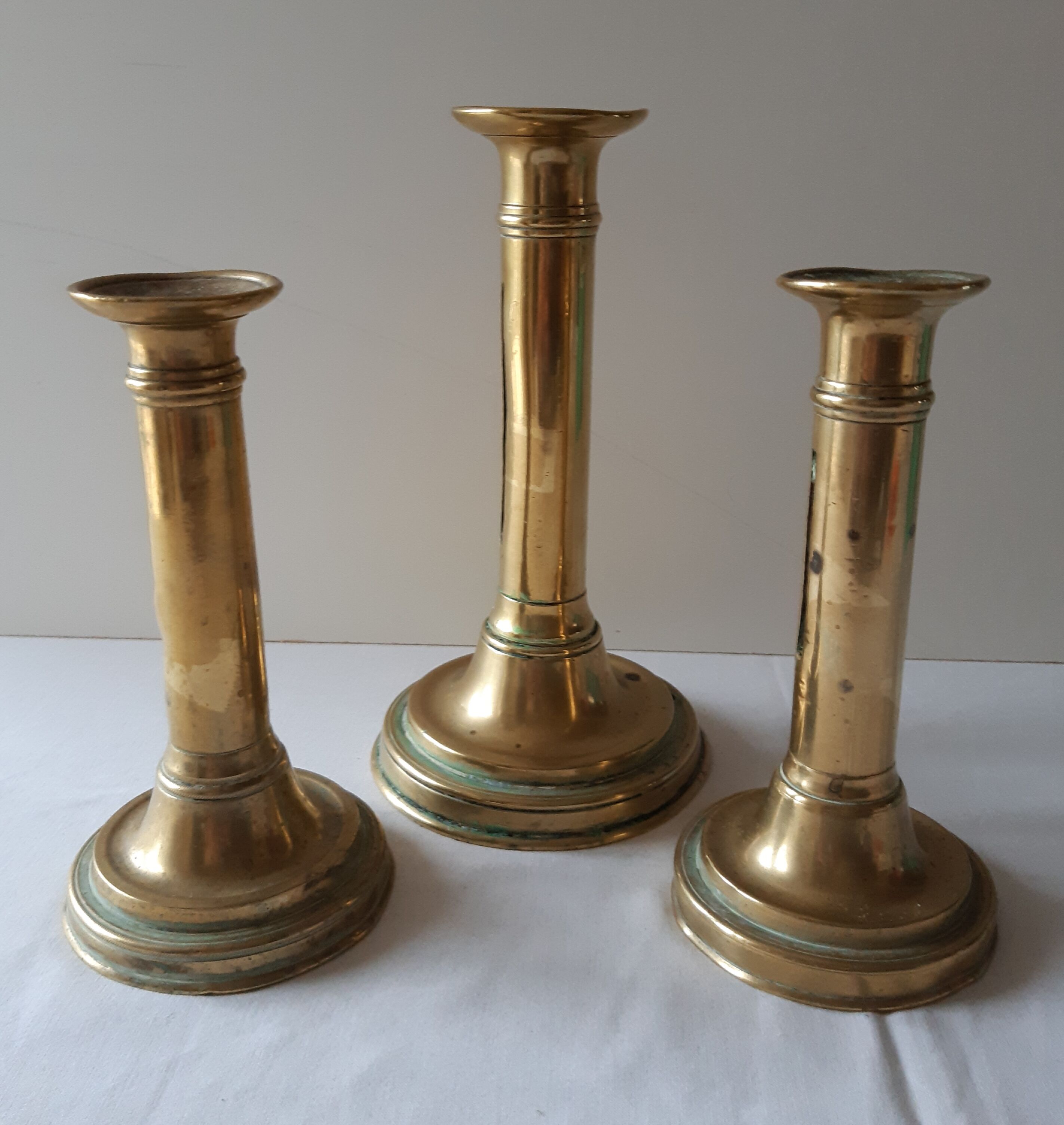 Lot of three old brass candlesticks