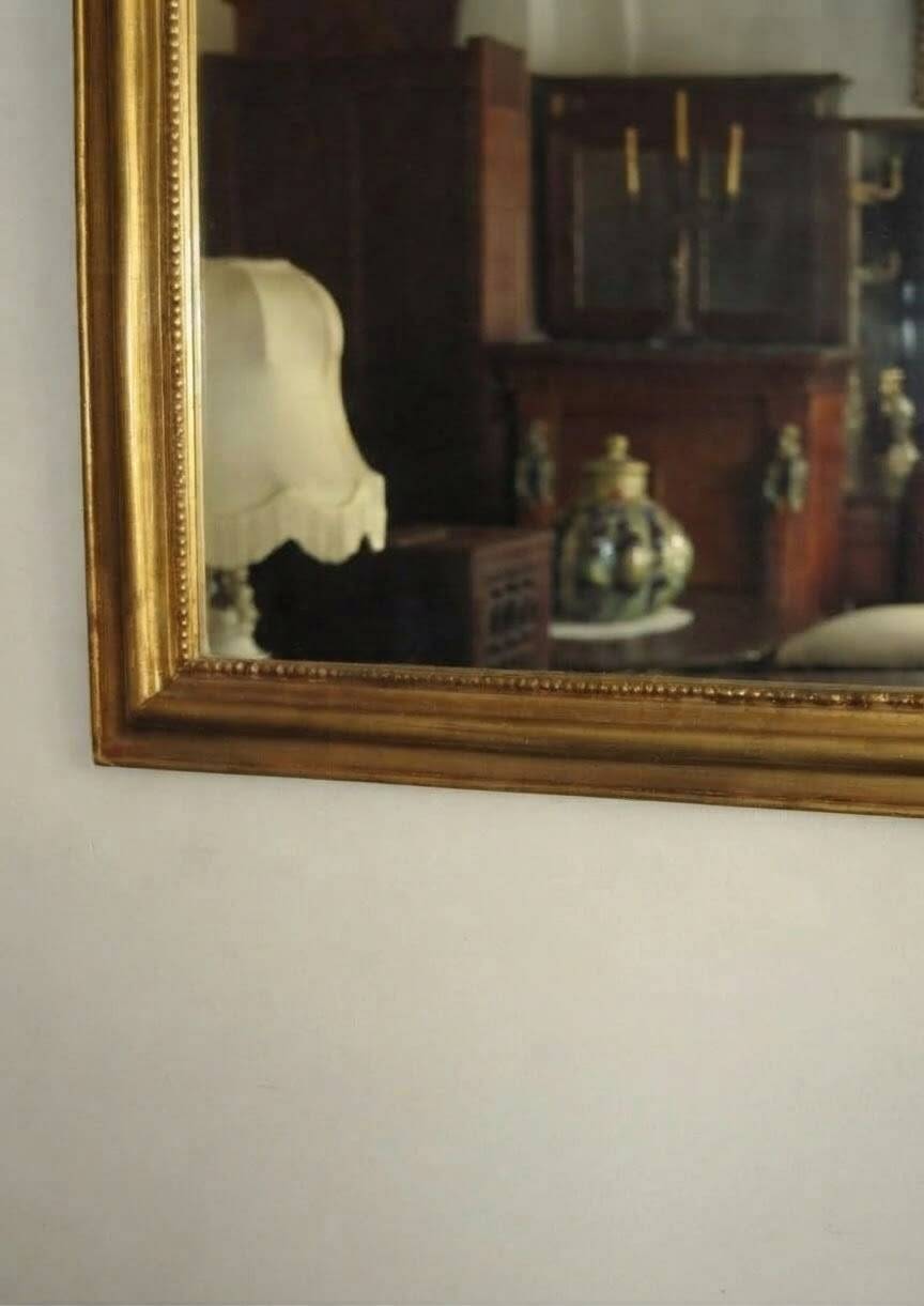 Gold wall mirror from the early 20th century.