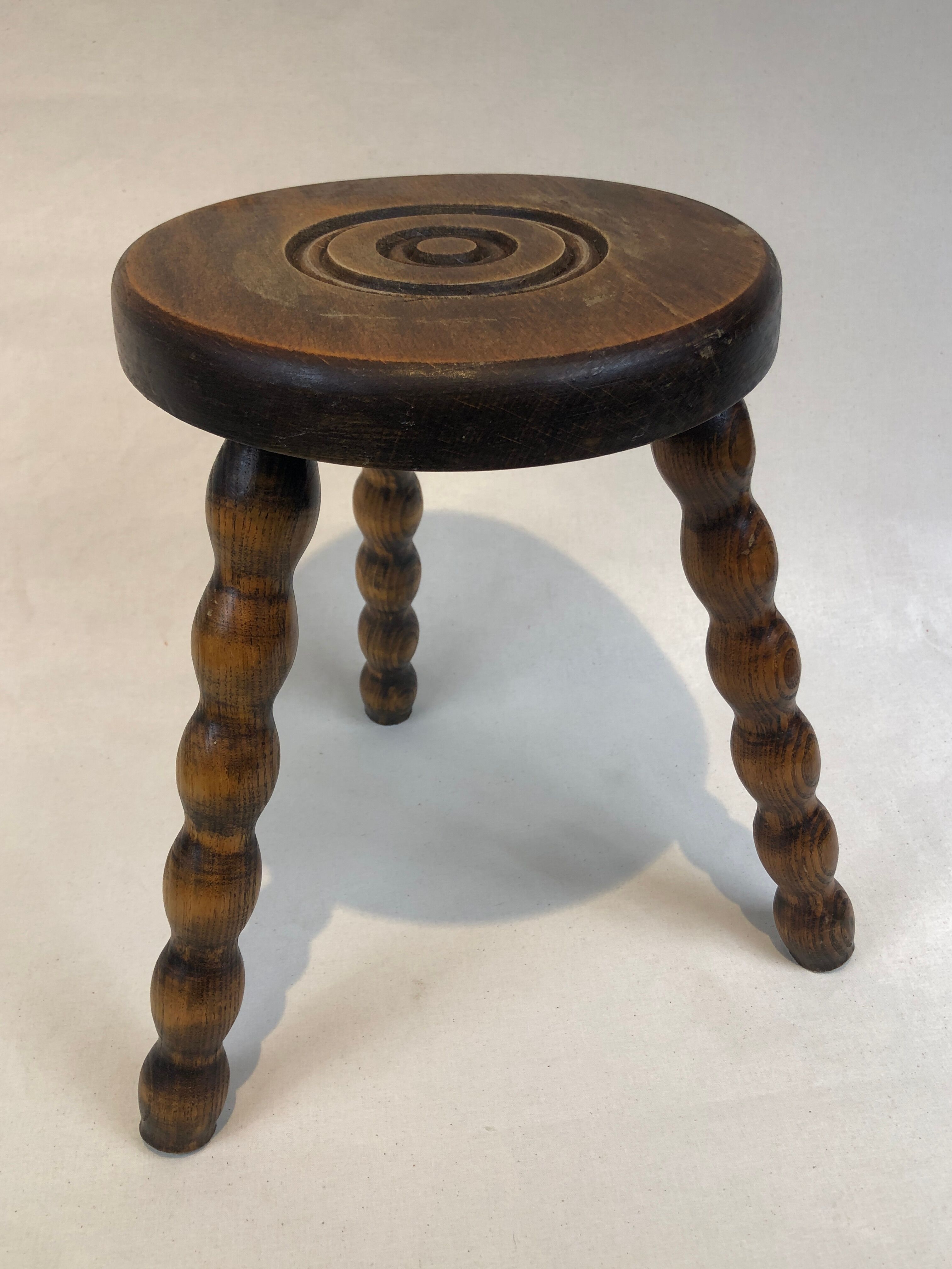 Dark turned wood tripod stool