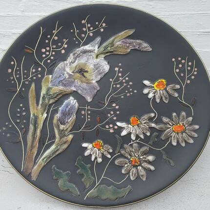 Black ceramic plate with wildflower design, Ruscha Art Pottery, Germany.