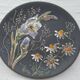 Black ceramic plate with wildflower design, Ruscha Art Pottery, Germany.