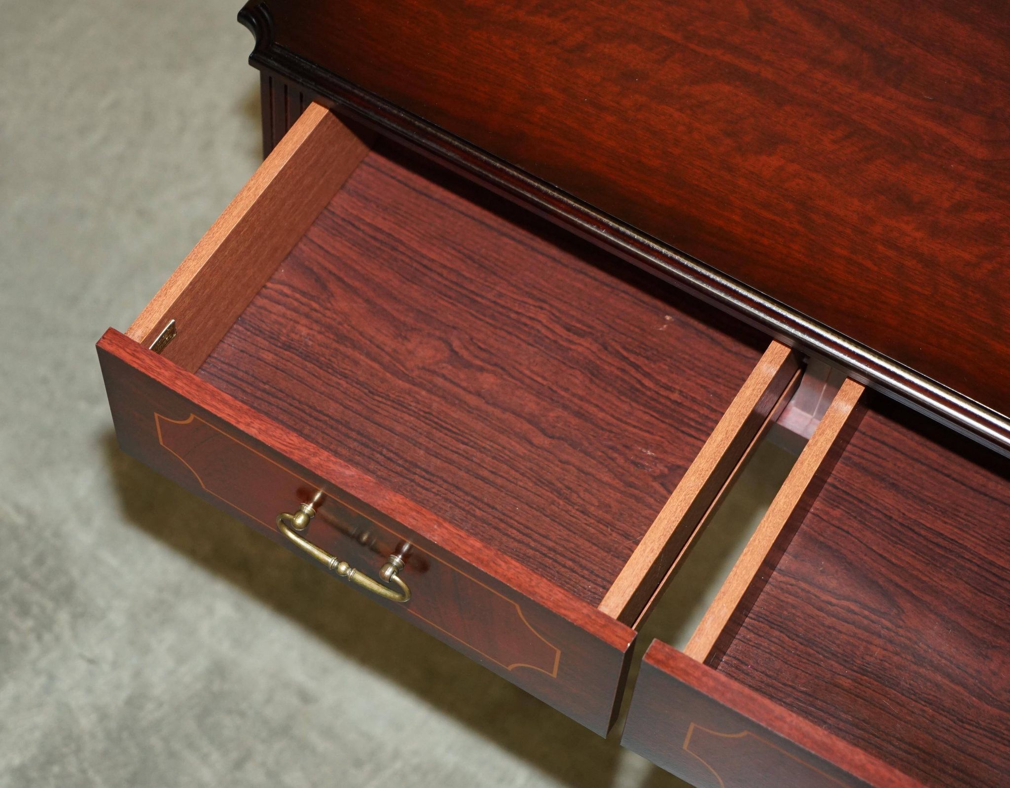 Small console with two drawers in hardwood finish.