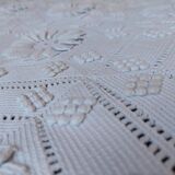 White bed throw with relief embroidery and floral patterns