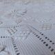 White bed throw with relief embroidery and floral patterns