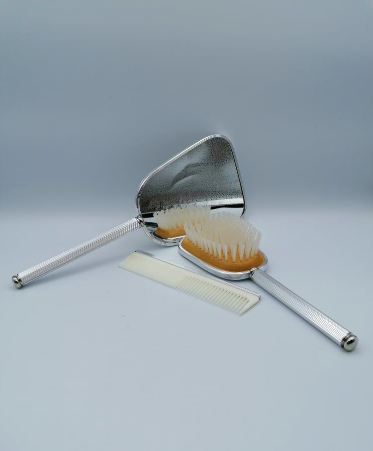 Hand mirror assembly, comb and brush.
