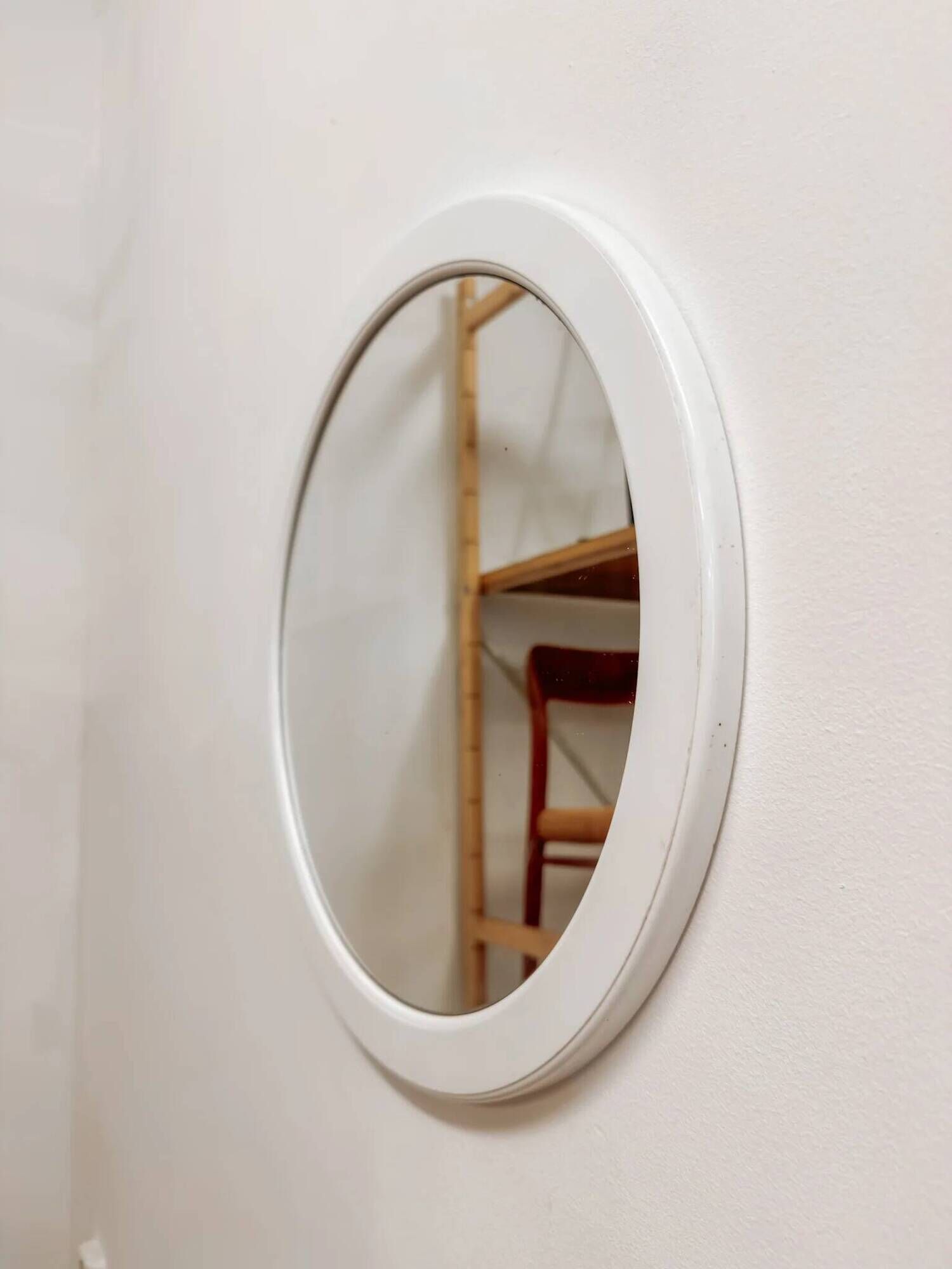 Large vintage round mirror with a white border.