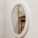 Large vintage round mirror with a white border.