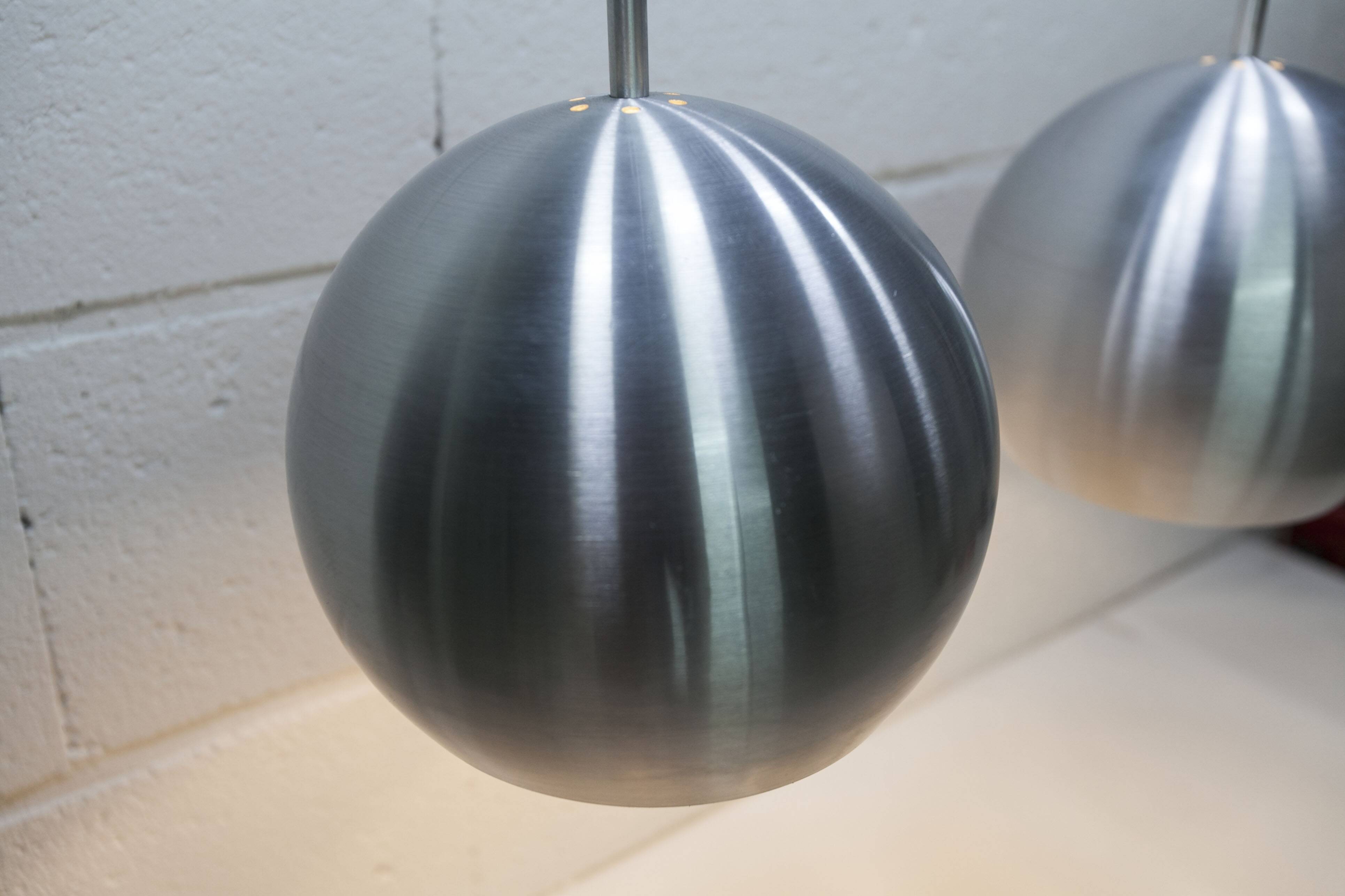 Pair of functional 70's aluminum ball pendants