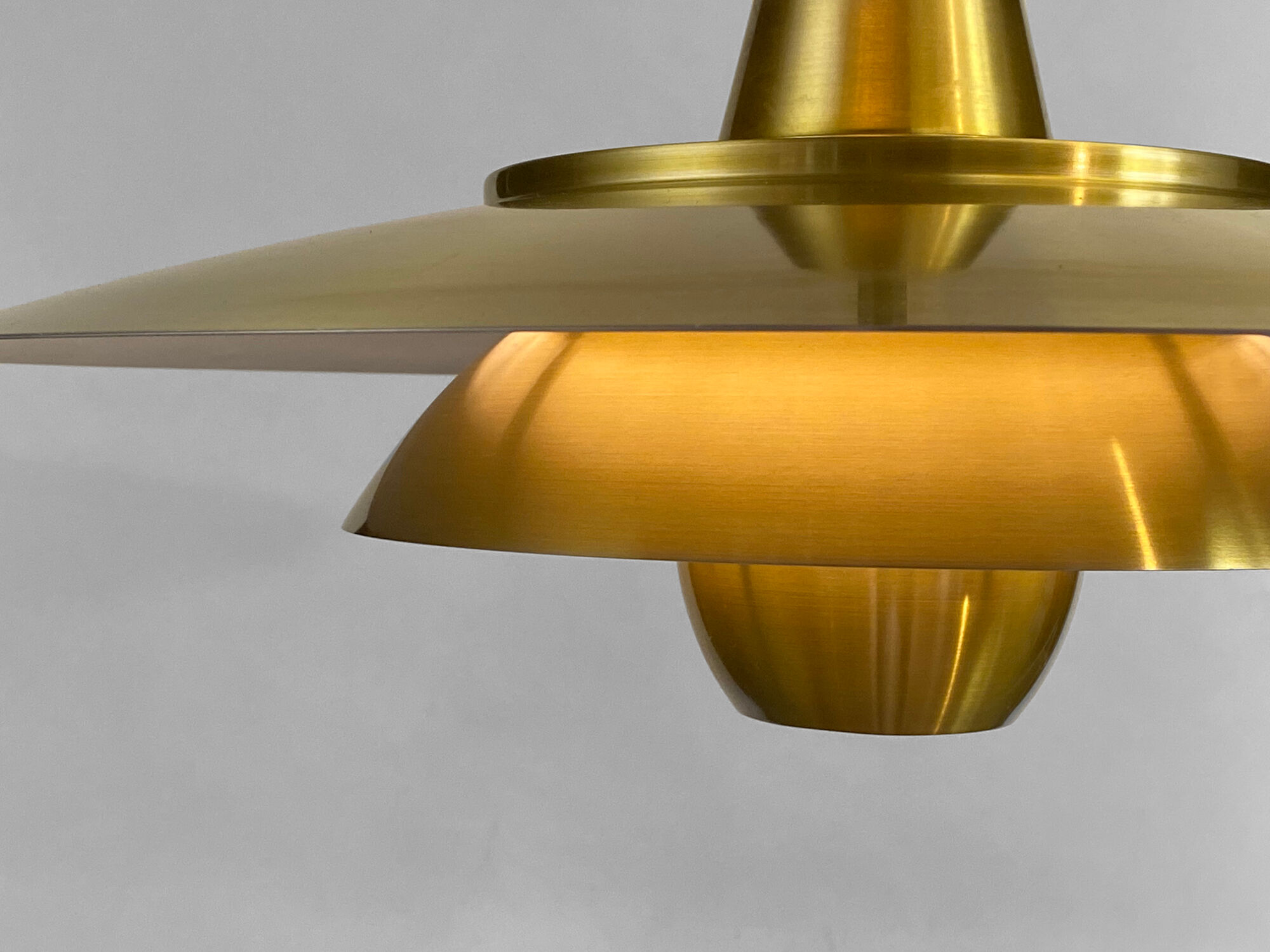 Large brushed aluminum pendant light with golden finish. Produced by Jeka. Denmark 1970s