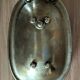Old soap dish in the shape of a brass bathtub