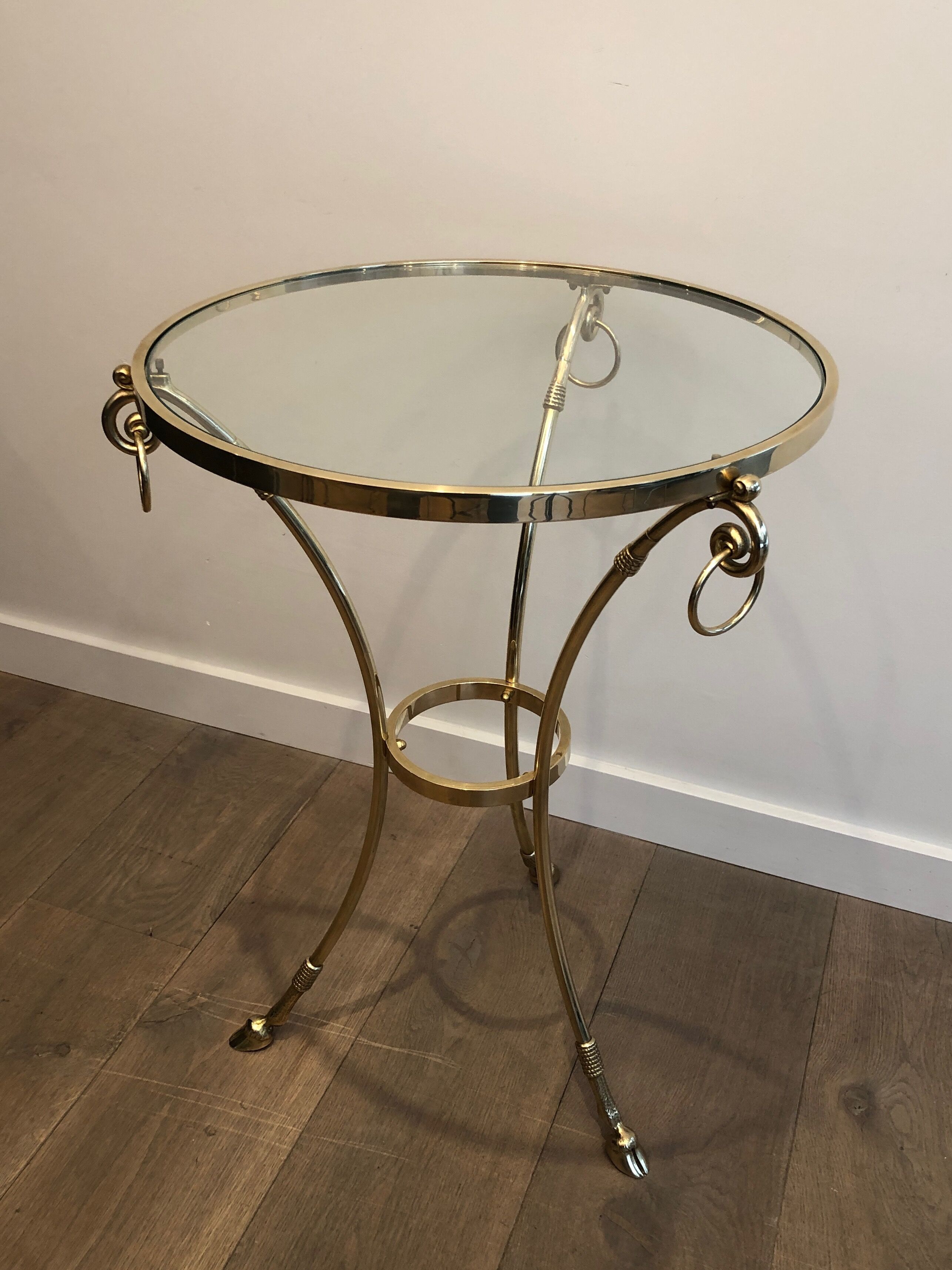 Neoclassical style tripod pedestal table in brass and round glass top in the taste of the House