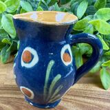 Small blue ceramic jug with hand-painted floral decoration, vintage.
