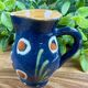 Small blue ceramic jug with hand-painted floral decoration, vintage.