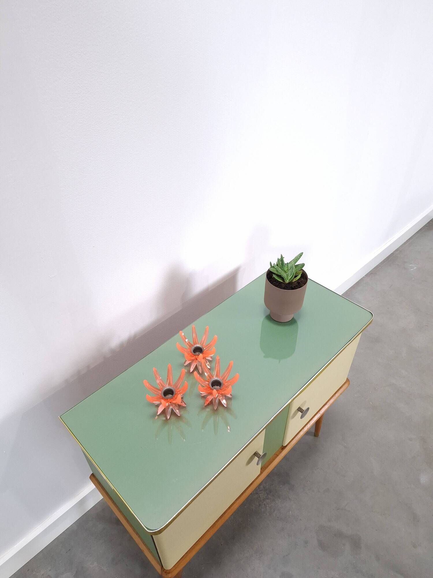Vintage green DDR cabinet, model Libelle with glass top, slanted legs.