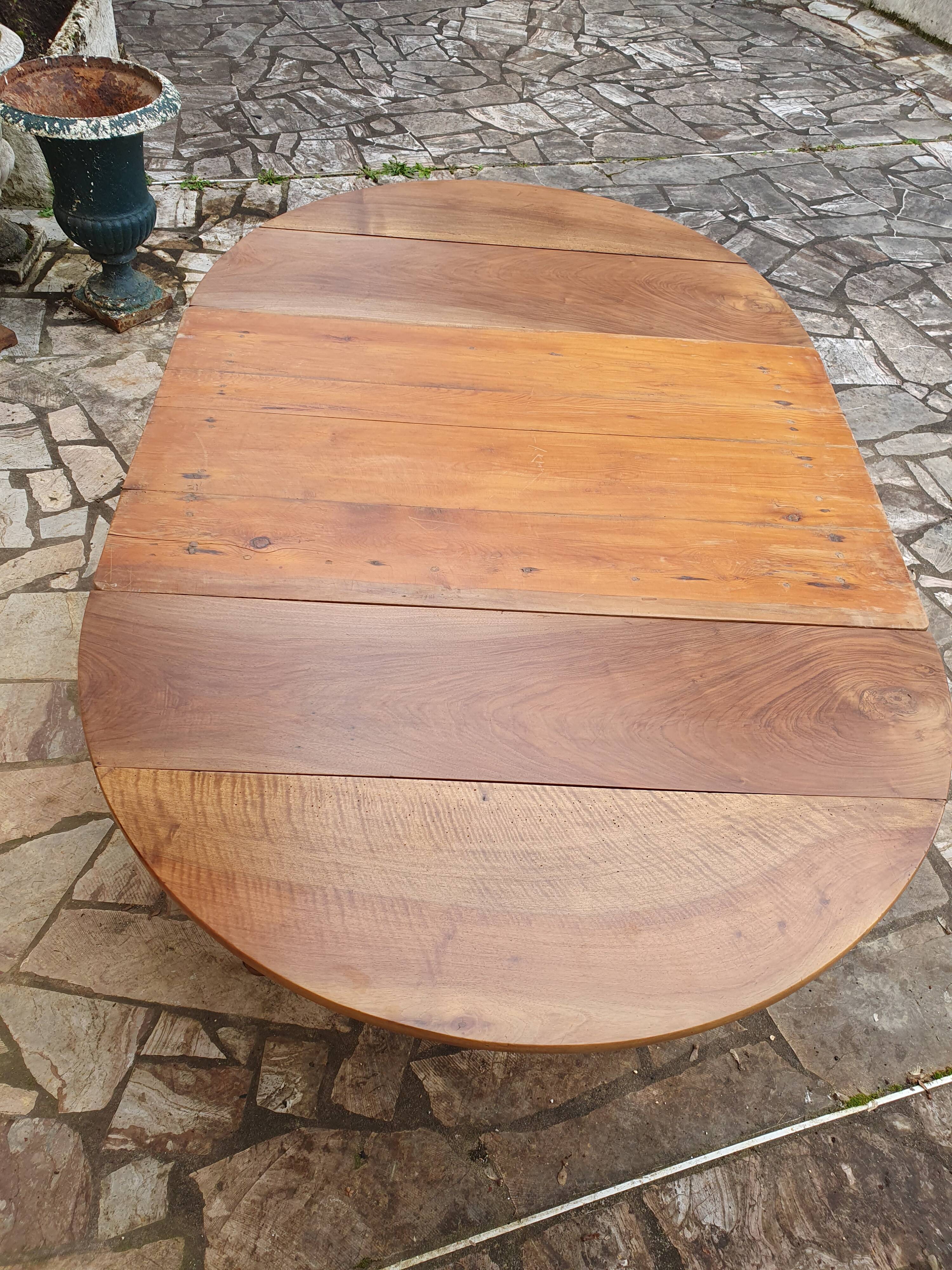 Round extending table in solid walnut, 19th century